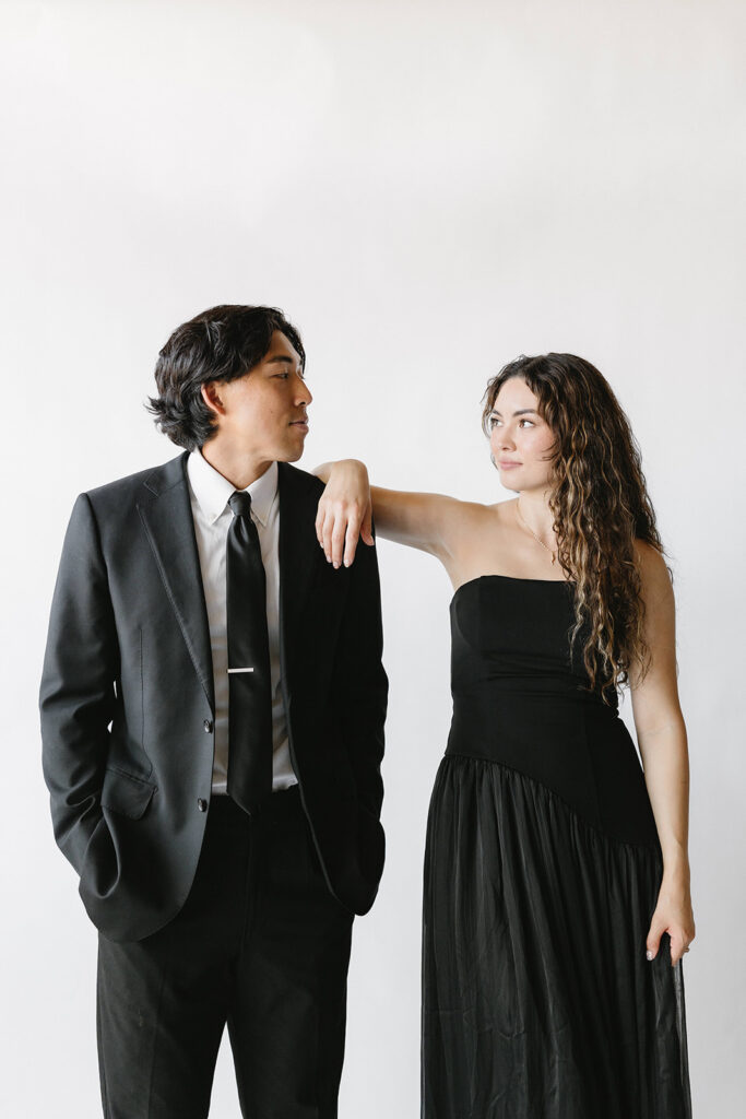 Bride and groom posing in modern photo booth at Southern California wedding reception